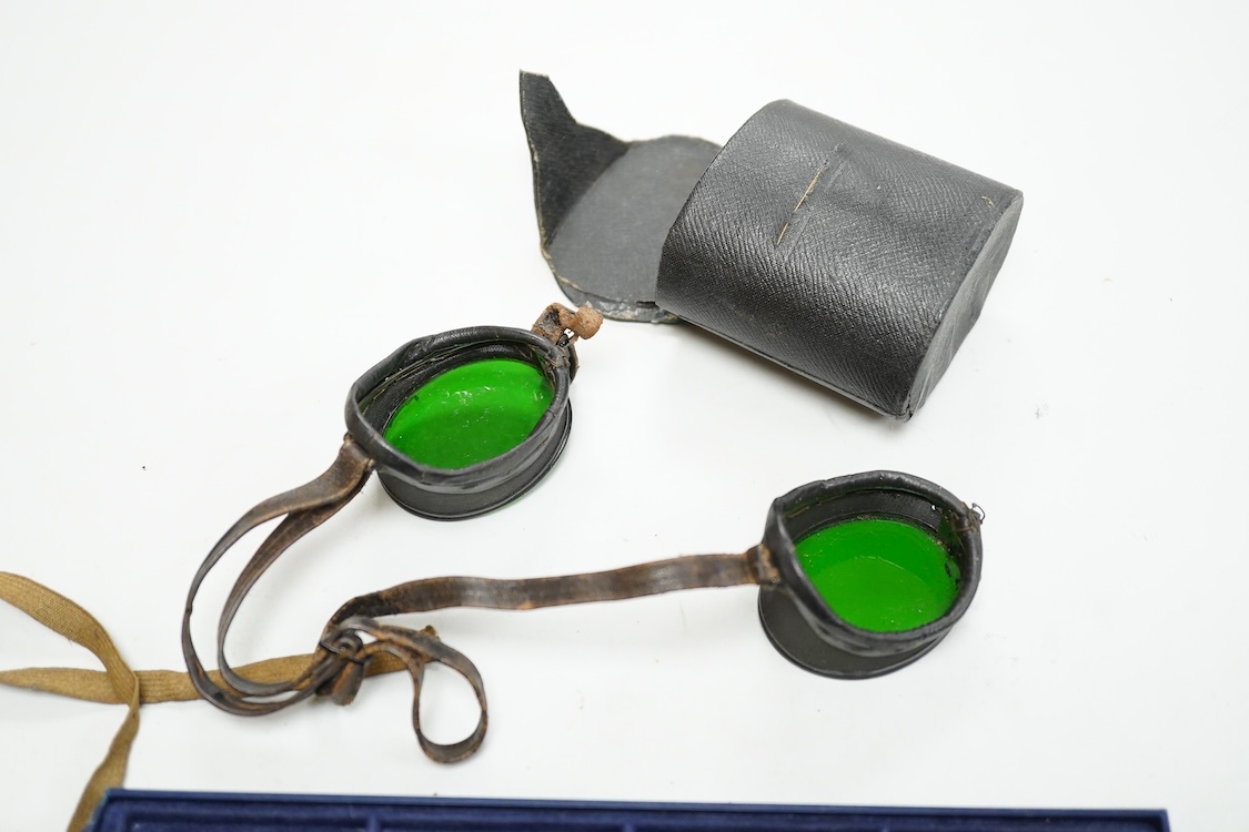 A pair of Wellsworth safety goggles with mesh sides, a pair of green tinted safety goggles with mesh sides, cased, and a pair of mesh wire sided safety spectacles with green tinted lenses (3)